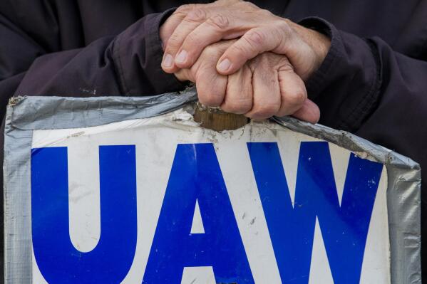 Dean Kennedy, a 66-year-old Corunna resident who has worked more than 46 years for General Motors as a repair technician at Flint Metal Fabrication, blocks an entrance to the Flint Metal Center, Oct. 17, 2019 in Flint, Mich. United Auto Workers union members who went on strike Saturday at the Stellantis casting plant in Indiana have reached a tentative deal with the company. The UAW Local 1166 bargaining committee confirmed the tentative agreement in a blog post, saying that a ratification vote would be held on Monday, Sept. 12, 2022. (Jake May/The Flint Journal via AP, file)