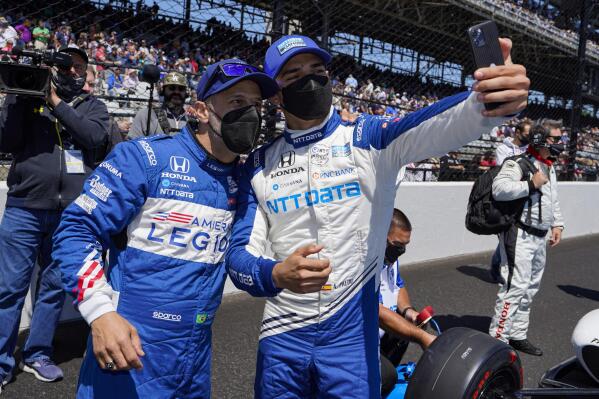 Tony Kanaan, left, of Brazil, and Alex Palou, of Spain, take a photo before the Indianapolis 500 auto race at Indianapolis Motor Speedway in Indianapolis, Sunday, May 30, 2021. (AP Photo/Michael Conroy)