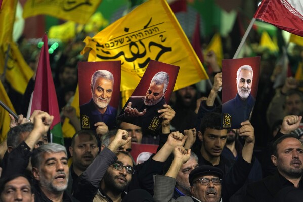 Iranian protesters chant slogans as they hold up posters of the late Iranian Revolutionary Guard Gen. Qassem Soleimani, who was killed in a U.S. drone attack in 2020, during their anti-Israeli gathering to condemn killing members of the Iranian Revolutionary Guard in Syria, at the Felestin (Palestine) Sq. in downtown Tehran, Iran, Monday, April 1, 2024. An Israeli airstrike that demolished Iran's consulate in Syria killed two Iranian generals and five officers, Syrian and Iranian officials said Monday. (AP Photo/Vahid Salemi)