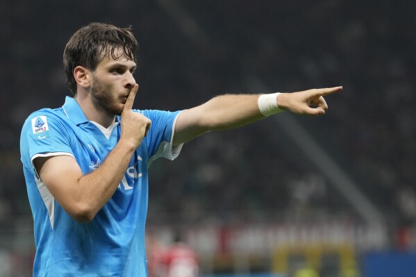 Napoli's Khvicha Kvaratskhelia celebrates after scoring his side's second goal during the Serie A soccer match between AC Milan and Napoli at the San Siro stadium, in Milan, Italy, Tuesday, Oct. 29, 2024. (AP Photo/Luca Bruno)