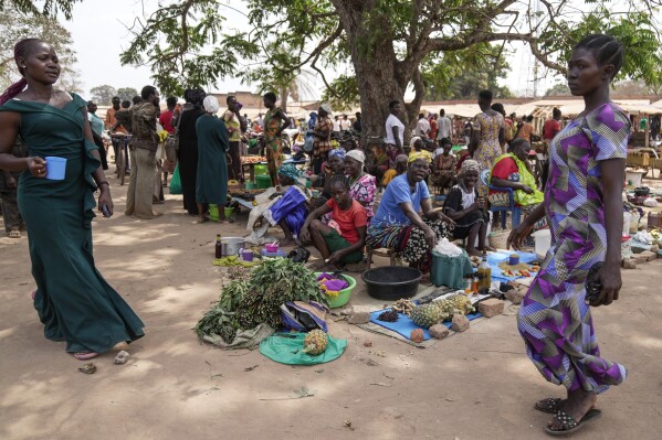 Women sell their goods at Nzara open market near Nzara, South Sudan on Saturday, Feb. 15, 2025. (AP Photo/Brian Inganga)