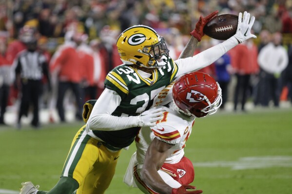 Green Bay Packers cornerback Carrington Valentine (37) breaks up a pass intended for Kansas City Chiefs wide receiver Marquez Valdes-Scantling (11) during the second half of an NFL football game Sunday, Dec. 3, 2023 in Green Bay, Wis. (APPhoto/Mike Roemer)