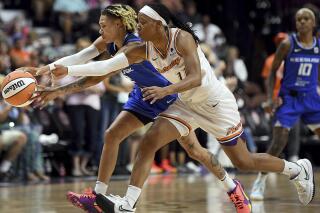 Connecticut Sun guard Natisha Hiedeman, left, and Phoenix Mercury guard Shay Peddy (11) reach for the ball during a WNBA basketball game Thursday, Aug. 4, 2022, in Uncasville, Conn. (Sarah Gordon/The Day via AP)