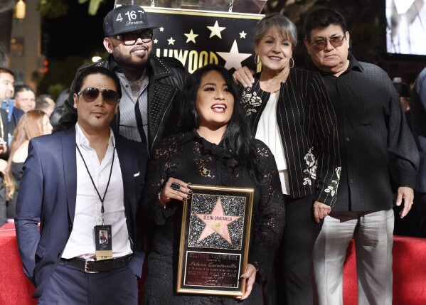 Suzette Quintanilla, center, sister of the late singer Selena Quintanilla, holds a replica of Selena's star on the Hollywood Walk of Fame as she poses with, from left, Selena's husband Chris Perez, her brother A.B. Quintanilla III, and her parents Marcella Ofelia Samora and Abraham Quintanilla Jr. during a posthumous ceremony on the Hollywood Walk of Fame in Los Angeles on Nov. 3, 2017. (Photo by Chris Pizzello/Invision/AP, File)