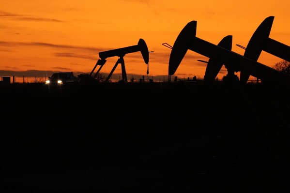 Oil Pump jacks work at dusk near Barnes City, Texas, Wednesday, Nov. 1, 2023. Despite frequent and devastating heat waves, droughts, floods and fire, major fossil fuel-producing countries still plan to extract more than double the amount of fossil fuels in 2030 than is consistent with the Paris climate accord’s goal for limiting global temperature rise, according to a U.N.-backed study released Wednesday, Nov. 8. (AP Photo/Eric Gay)