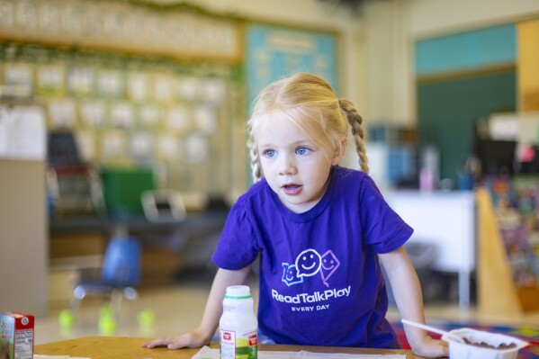 Emery Lankford, a 4-year-old preschooler at Hillcrest Developmental Preschool, takes a break from schoolwork to eat lunch. The one-stoplight farming community in conservative Idaho has embraced a goal that backers describe as progressive: universal preschool. (AP Photo/Kyle Green)
