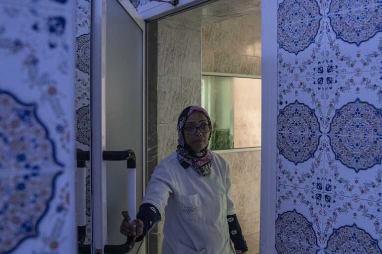 A worker at an empty Moroccan traditional bath, known as hammam, in Rabat, Morocco, Monday, March 4, 2024. Climate change and a yearslong drought have forced Morocco's famous public baths to close a few days a week in an effort to save water. (AP Photo/Mosa'ab Elshamy)