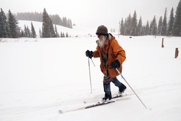 Billy Barr skis Wednesday, March 13, 2024, in Gothic, Colo. So-called “citizen scientists” like Barr have long played important roles in gathering data to help researchers better understand the environment. His once hand-recorded measurements have informed numerous scientific papers and helped calibrate aerial snow sensing tools. (AP Photo/Brittany Peterson)