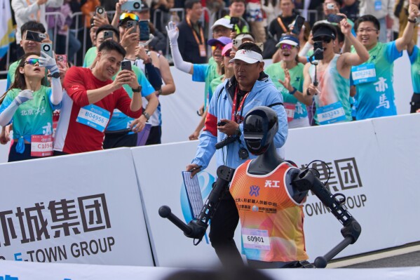 The Sky Project Ultra robot also known as Tien Kung Ultra crosses the finish line to win the Humanoid Robot Half-Marathon held in Beijing on Saturday, April 19, 2025. (AP Photo/Ng Han Guan)