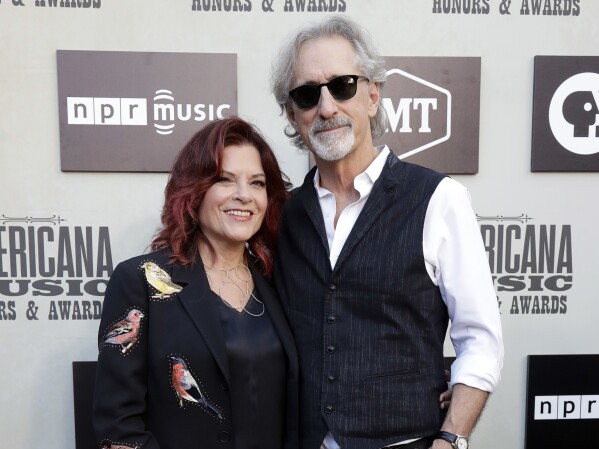FILE - Rosanne Cash, left, and John Leventhal arrive at the Americana Honors and Awards show Wednesday, Sept. 12, 2018, in Nashville, Tenn. Leventhal has won six Grammys for songwriting and producing. And now, at 71, he's releasing an album of his own music, some of which features wife Rosanne Cash. (AP Photo/Mark Zaleski, File)