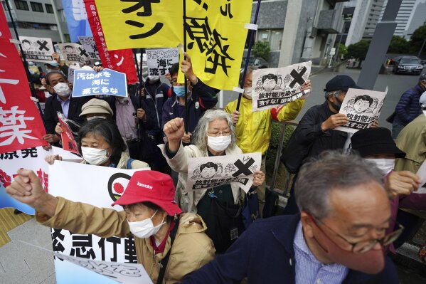 People chant slogans against government's decision to start releasing massive amounts of treated radioactive water from the wrecked Fukushima nuclear plant into the sea, during a rally outside the prime minister's office in Tokyo Tuesday, April 13, 2021. The decision, long speculated but delayed for years due to safety concerns and protests, came at a meeting of Cabinet ministers who endorsed the ocean release as the best option. (AP Photo/Eugene Hoshiko)
