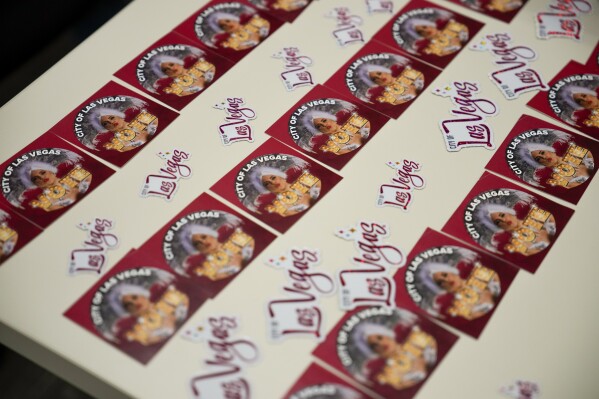 Voting stickers are displayed on a table at a polling place inside City Hall, Tuesday, Nov. 5, 2024, in Las Vegas. (AP Photo/John Locher)