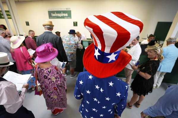 Tre Moser wears patriotic clothing at Churchill Downs before the 151st running of the Kentucky Oaks horse race Friday, May 2, 2025, in Louisville, Ky. (AP Photo/Charlie Riedel)