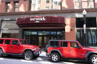 The WeWork logo on the facade of a commercial real estate, shared workspace, Wednesday, July 14, 2021, in Boston. WeWork is set to go public on Thursday, Oct. 21, 2021, its second attempt at a stock offering following a spectacular collapse two years ago.(AP Photo/Charles Krupa)