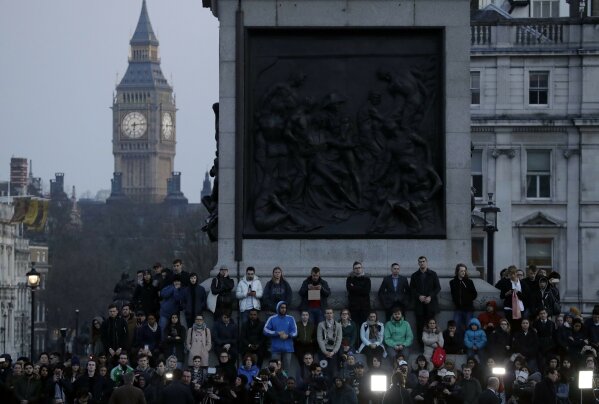 
              People observe a minutes silence at a vigil for the victims of Wednesday's attack, at Trafalgar Square in London, Thursday, March 23, 2017. The Islamic State group has claimed responsibility for an attack by a man who plowed an SUV into pedestrians and then stabbed a police officer to death on the grounds of Britain's Parliament. Mayor Sadiq Khan called for Londoners to attend a candlelit vigil at Trafalgar Square on Thursday evening in solidarity with the victims and their families and to show that London remains united. (AP Photo/Matt Dunham)
            