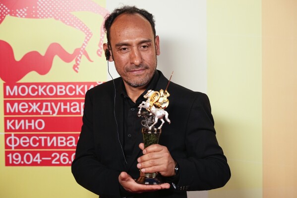 Mexican director Miguel Salgado poses with his the Golden Saint George trophy for a photo after the closing ceremony of the 46th Moscow International Film Festival in Moscow, Russia, on Friday, April 26, 2024. A Mexican film has won the top prize at the Moscow International Film Festival which took place as major Western studios boycott the Russian market and as Russia's war in Ukraine grinds into its third year. "Shame," a film by director Miguel Salgado and co-produced by Mexico and Qatar, was the most highly awarded film at the festival which began in 1935 and which has been held annually since 1999. (AP Photo/Alexander Zemlianichenko)