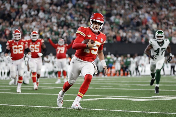 Kansas City Chiefs quarterback Patrick Mahomes (15) runs for a first down against the New York Jets during the fourth quarter of an NFL football game, Sunday, Oct. 1, 2023, in East Rutherford, N.J. (AP Photo/Adam Hunger)