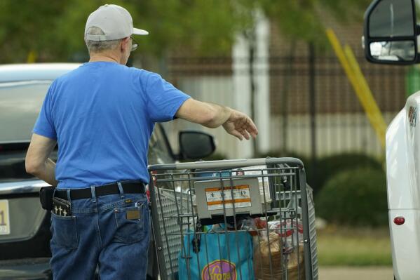 A shopper removes his purchases from his cart in Jackson, Miss., Wednesday, Oct. 12, 2022.  Any Americans hoping for relief from months of punishing inflation might not see much in an upcoming government report on price increases in September. (AP Photo/Rogelio V. Solis)