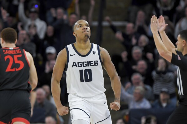 Utah State guard Darius Brown II (10) reacts after making a 3-pointer against San Diego State during the second half of an NCAA college basketball game Tuesday, Feb. 20, 2024, in Logan, Utah. (Eli Lucero/The Herald Journal via AP)