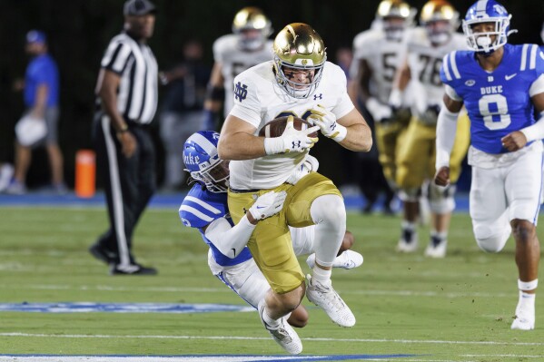 Notre Dame's Mitchell Evans (88) completes a catch ahead of Duke's Brandon Johnson (3) during the first half of an NCAA college football game in Durham, N.C., Saturday, Sept. 30, 2023. (AP Photo/Ben McKeown)