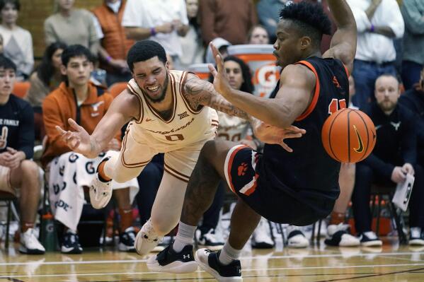 Texas forward Timmy Allen (0) is fouled by Sam Houston State guard Javion May (11) during the second half of an NCAA college basketball game, Monday, Nov. 29, 2021, in Austin, Texas. (AP Photo/Eric Gay)