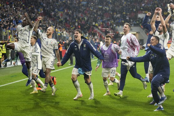 Italy players celebrate their qualifying after the Euro 2024 group C qualifying soccer match between Ukraine and Italy at the BayArena in Leverkusen, Germany, Monday, Nov. 20, 2023. (AP Photo/Martin Meissner)