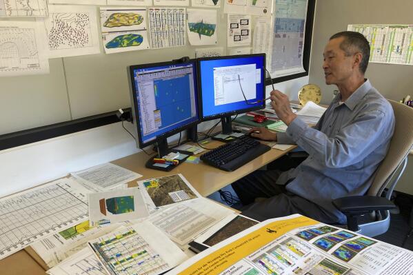 Geologist John Jiao looks at computer simulations of how wells could store carbon dioxide underground Aug. 10, 2022, at the University of Wyoming School of Energy Resources in Laramie, Wyo. New federal tax credits and billions of dollars in new funding are likely to boost such efforts to counter climate change. (AP Photo/Mead Gruver)