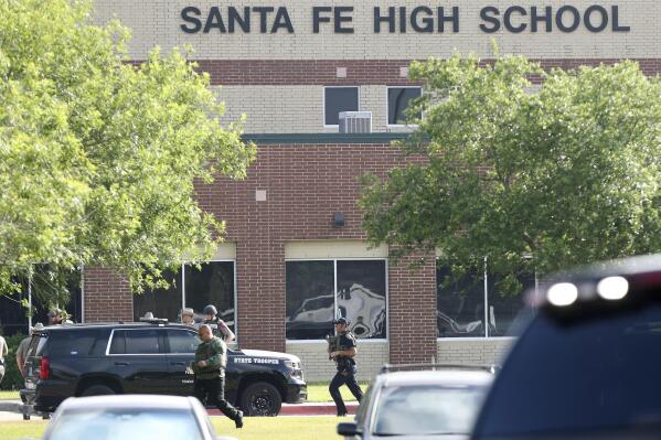 FILE - Law enforcement officers respond to Santa Fe High School after an active shooter was reported on campus in Santa Fe, Texas, May 18, 2018. An emotional audition on “American Idol” by Trey Louis, a survivor of a 2018 Texas high school shooting, prompted tears from the judges as well as criticism of the country’s response to gun violence. Louis was one of the students at Santa Fe High School in May 2018 when another student fatally shot 10 people on campus. (Steve Gonzales/Houston Chronicle via AP, File)