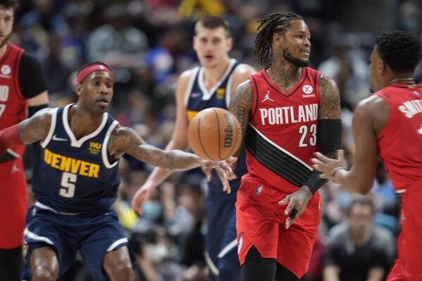 Portland Trail Blazers guard Ben McLemore, center, passes the ball to guard Dennis Smith Jr., right, as Denver Nuggets forward Will Barton defends in the second half of an NBA basketball game Thursday, Jan. 13, 2022, in Denver. The Nuggets won 140-108. (AP Photo/David Zalubowski)