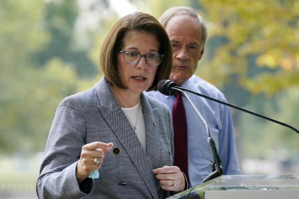 FILE - Sen. Catherine Cortez Masto, D-Nev., left, speaks alongside Sen. Tom Carper, D-Del., at a news conference to advocate for additional investments in zero-emission school buses on Capitol Hill in Washington, Sept.14, 2021. Cortez Masto raised $3.3 million the last three months of 2021 in her bid for re-election in the swing-state of Nevada, more than twice as much as either of the leading candidates seeking the Republican nomination to try to unseat her. (AP Photo/Patrick Semansky, File)