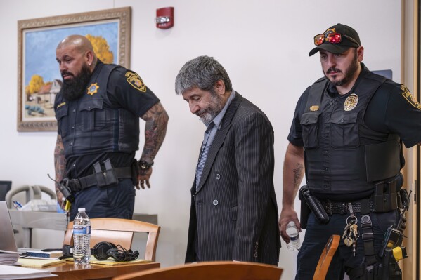 Muhammad Syed enters the court room before opening statements at the Bernalillo County Courthouse in Downtown Albuquerque, N.M,, on Tuesday, March 12, 2024. Syed, an Afghan refugee, is accused in the slayings of three Muslim men in Albuquerque. (Chancey Bush/The Albuquerque Journal via AP, Pool)