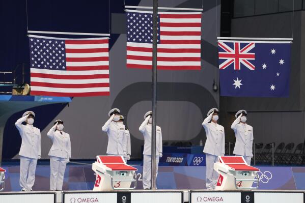 The flags are raised for the medal ceremony for the men's 400 meter individual medley at the 2020 Summer Olympics, Sunday, July 25, 2021, in Tokyo, Japan. (AP Photo/Martin Meissner)