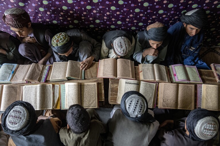 Boys read books in a religious school in Afghanistan, on Sunday, Feb. 26, 2023. (AP Photo/Ebrahim Noroozi)