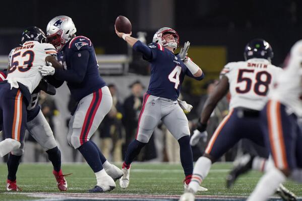 New England Patriots quarterback Bailey Zappe (4) throws a deep pass to wide receiver DeVante Parker during the first half of an NFL football game against the Chicago Bears, Monday, Oct. 24, 2022, in Foxborough, Mass. (AP Photo/Steven Senne)