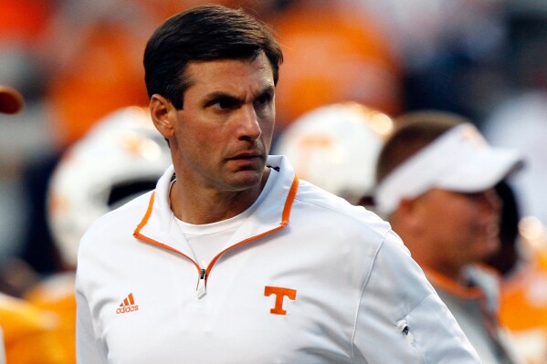 Tennessee Volunteers head coach Derek Dooley watches his team warm up before an NCAA college football game on Sept. 22, 2012, in Knoxville, Tenn. (AP Photo/Wade Payne, File)