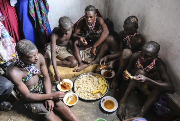 ImageYoung men, eat a meal prior to their traditional circumcision ritual, known as Imbalu, at Kamu village in Mbale, Eastern Uganda, Saturday, Aug. 3, 2024. (AP Photo/Hajarah Nalwadda)