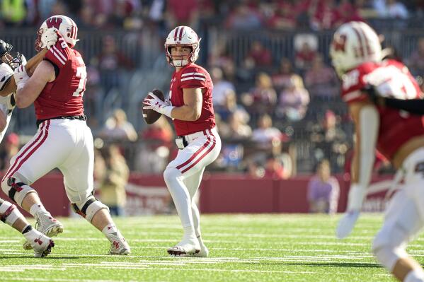 Wisconsin quarterback Graham Mertz (5) looks to pass against Purdue during the first half of an NCAA college football game Saturday, Oct. 22, 2022, in Madison, Wis. Wisconsin won 35-24. (AP Photo/Andy Manis)