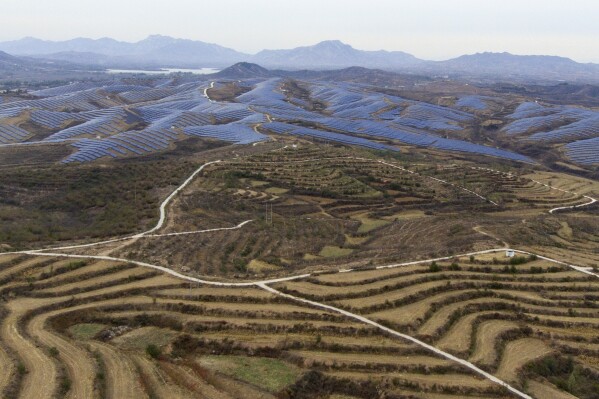 A solar farm operates next to Donggou village in the northern China's Hebei province, Friday, Nov. 10, 2023. Solar is now the cheapest form of electricity in a majority of countries. (AP Photo/Ng Han Guan)