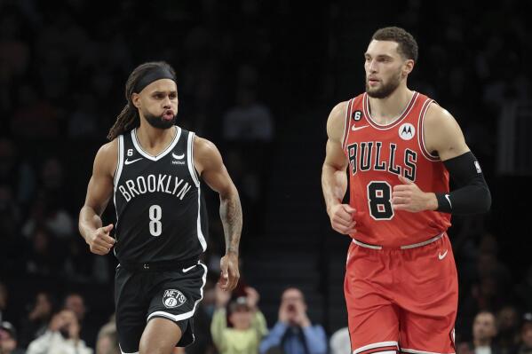 Brooklyn Nets guard Patty Mills, left, reacts after scoring a 3-pointer as Chicago Bulls guard Zach LaVine runs to the other end of the court during the first half of an NBA basketball game Tuesday, Nov. 1, 2022, in New York. (AP Photo/Jessie Alcheh)
