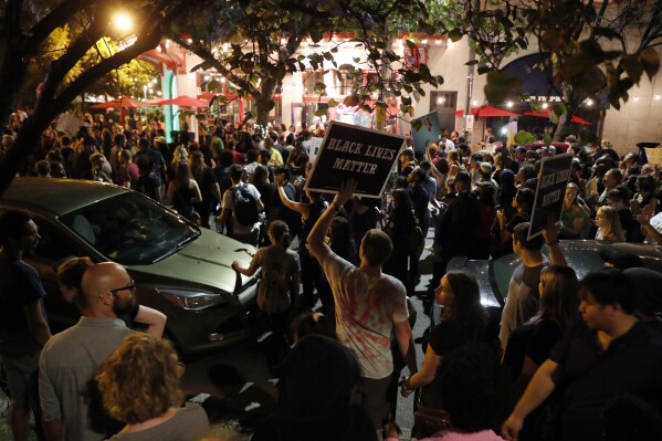 FILE - Protesters gather in St. Louis, Sept. 15, 2017, after a judge found a white former St. Louis police officer, Jason Stockley, not guilty of first-degree murder in the death of a black man, Anthony Lamar Smith, who was fatally shot following a high-speed chase in 2011. Some of the people who were arrested during a 2017 protest over the acquittal of Stockley in the shooting death of Smith have started receiving their share of a $4.9 million settlement the city agreed to. The first checks were distributed Friday, Aug. 4, 2023, to some of the 84 people covered by the settlement. (AP Photo/Jeff Roberson, File)