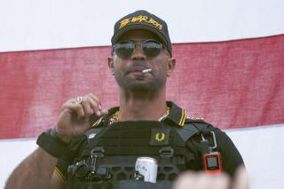 FILE - Proud Boys leader Henry "Enrique" Tarrio wears a hat that says The War Boys during a rally in Portland, Ore., on Sept. 26, 2020. A legal fight has erupted over a Washington D.C. police officer who was communicating with Tarrio in the run-up to the Jan. 6, 2021, Capitol attack that could shape the outcome of the upcoming trial of Tarrio and other far-right extremists. (AP Photo/Allison Dinner, File)