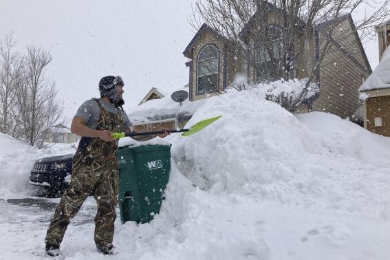 Ronnie Enriquez shovels snow from his driveway Wednesday, March 1, 2023, in Bellemont, Ariz. In Arizona, snow began falling Wednesday morning as the storm moved eastward and was poised to dump as much as 2 feet (60 centimeters) of snow in northern Arizona by Thursday morning. (AP Photo/Felicia Fonseca)
