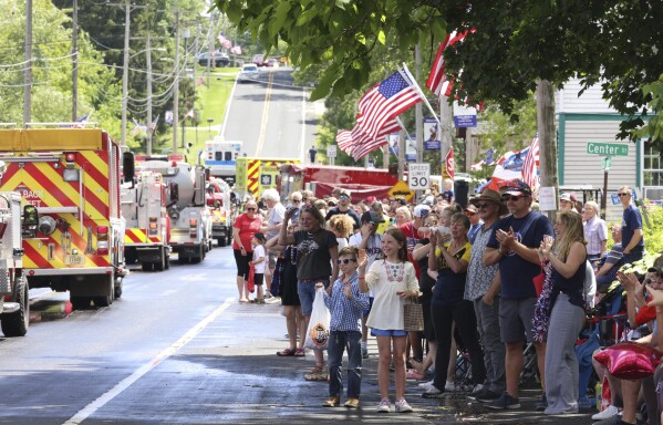 Children watch a parade on June 9, 2024, in Waubeka, Wis. Old Glory is venerated annually in Waubeka, the small town that lays claim to the first Flag Day. (AP Photo/Teresa Crawford)