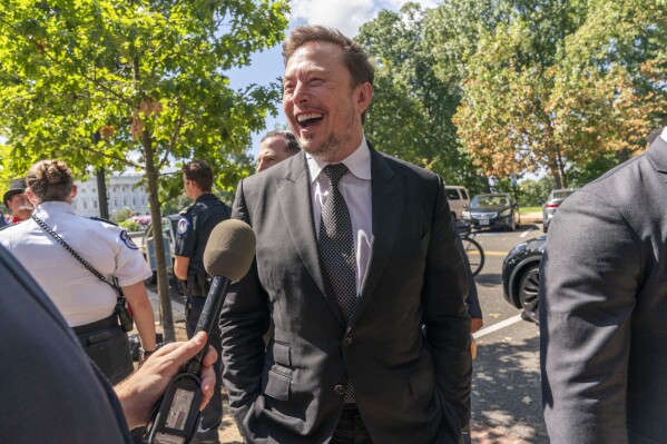Elon Musk, CEO of X, the company formerly known as Twitter, laughs while speaking to the media after attending a closed-door gathering of leading tech CEOs to discuss the priorities and risks surrounding artificial intelligence and how it should be regulated, on Capitol Hill in Washington, Wednesday, Sept. 13, 2023. (AP Photo/Jacquelyn Martin)
