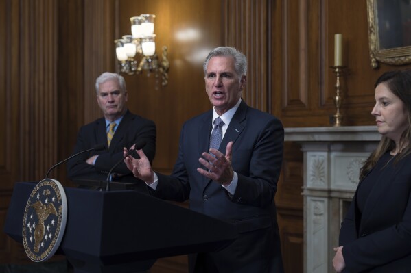 Speaker of the House Kevin McCarthy, R-Calif., flanked by Majority Whip Tom Emmer, R-Minn., left, and Republican Conference Chair Elise Stefanik, R-N.Y., holds a news conference just after the House approved a 45-day funding bill to keep federal agencies open, but the measure must first go to the Senate, at the Capitol in Washington, Saturday, Sept. 30, 2023. (AP Photo/J. Scott Applewhite)