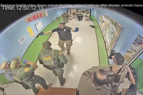 FILE - In this photo from surveillance video provided by the Uvalde Consolidated Independent School District via the Austin American-Statesman, authorities respond to the shooting at Robb Elementary School in Uvalde, Texas, on May 24, 2022. A Justice Department report released Thursday, Jan. 18, 2024 details a myriad of failures by police who responded to the Uvalde, Texas school shooting that led to children waiting desperately for over an hour before officers stormed a classroom to take down the gunman. (Uvalde Consolidated Independent School District/Austin American-Statesman via AP, File)