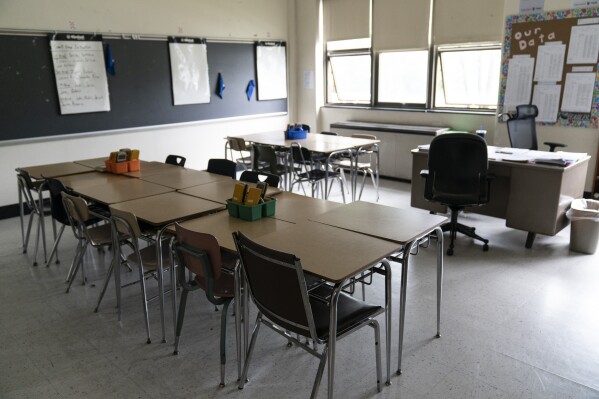FILE - Desks fill a classroom in a high school in Pennsylvania on Wednesday, May 3, 2023. Gaps between how minority students perform academically in comparison to their white peers have long been an issue across the country. The disparities often stem from larger structural issues — a lack of access to quality curricula, for instance, or teachers expecting students to perform poorly. (AP Photo/Matt Rourke, File)