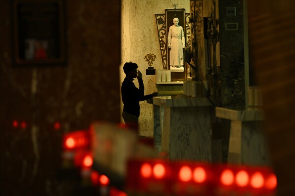 A St. Rita High School student prays in the school chapel where the new Pope Leo XIV, Chicago native Cardinal Robert Prevost, was a substitute teacher, Thursday, May 8, 2025, in Chicago. (AP Photo/Paul Beaty)