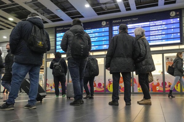 FILE - People watch an information screen at the main train station in Essen, Germany, when most trains were cancelled on Thursday, Nov. 16, 2023. A union representing German train drivers is calling its members out on strike from the evening of Thursday, Dec. 6 to Friday evening following the breakdown of talks with the main national operator in what is shaping up to be an unusually difficult dispute over pay and working hours. (AP Photo/Martin Meissner)
