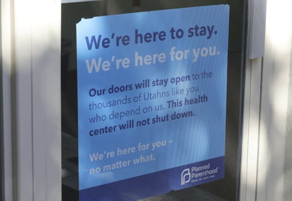 A sign is displayed on the door of Planned Parenthood of Utah Wednesday, Aug. 21, 2019, in Salt Lake City. About 39,000 people received treatment from Planned Parenthood of Utah in 2018 under a federal family planning program called Title X. The organization this week announced it is pulling out of the program rather than abide by a new Trump administration rule prohibiting clinics from referring women for abortions. (AP Photo/Rick Bowmer)